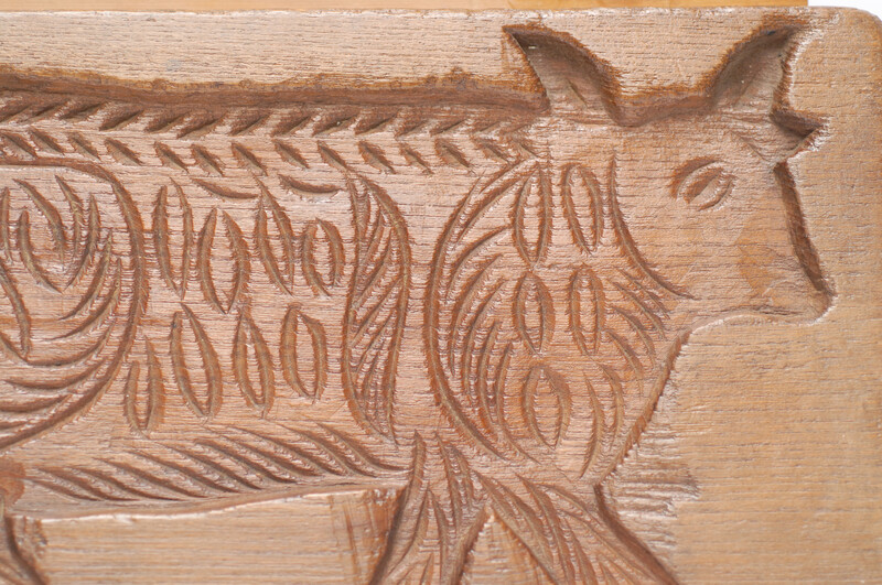 An eighteenth century double sided Dutch cookie mould with a man on a horse and on the other side a cow.