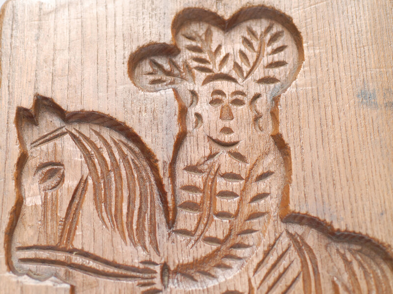 An eighteenth century double sided Dutch cookie mould with a man on a horse and on the other side a cow.