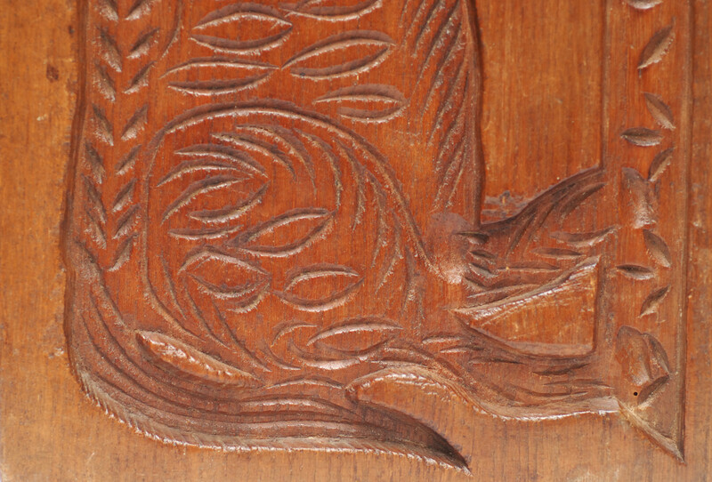 An eighteenth century double sided Dutch cookie mould with a man on a horse and on the other side a cow.