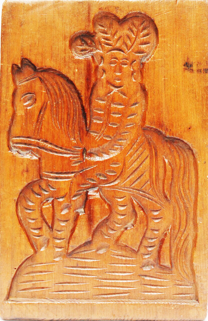 An eighteenth century double sided Dutch cookie mould with a man on a horse and on the other side a cow.