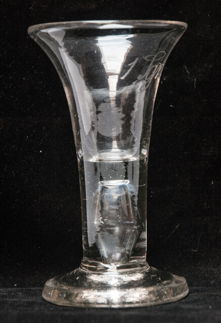 An eighteenth century Dutch glass tot with inscription for medical use.