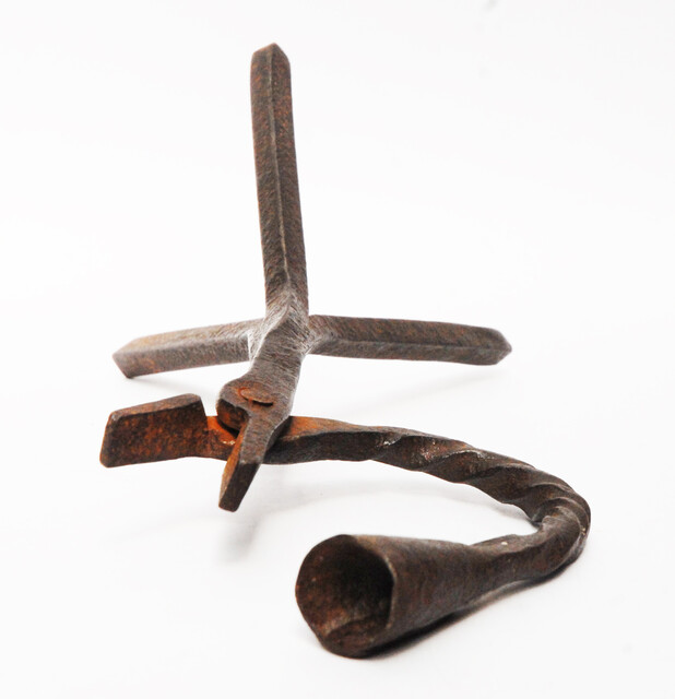 An eighteenth century Dutch rush clamp and candlestick.