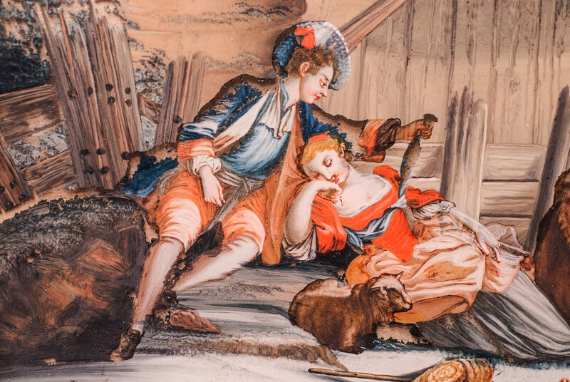 An eighteenth century reverse painting on glass. In a black frame.