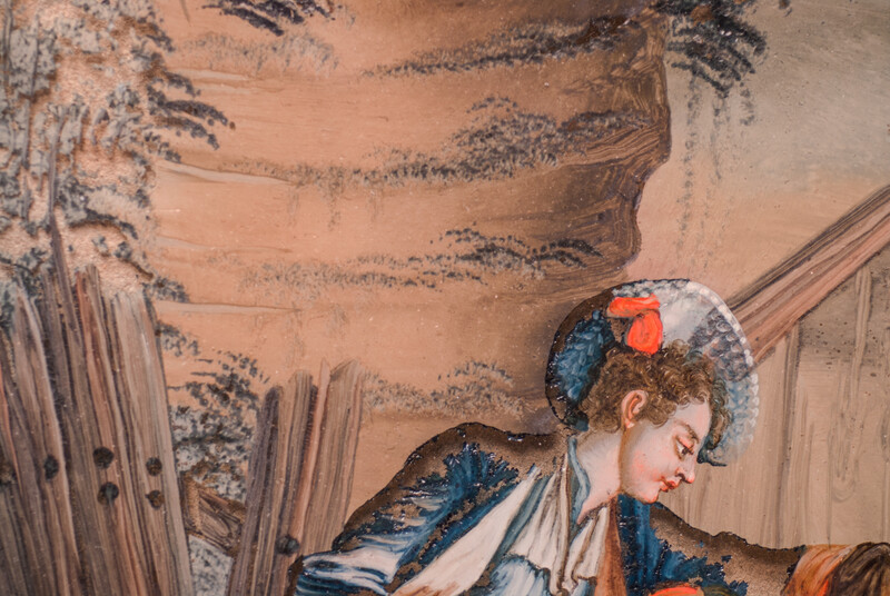 An eighteenth century reverse painting on glass. In a black frame.