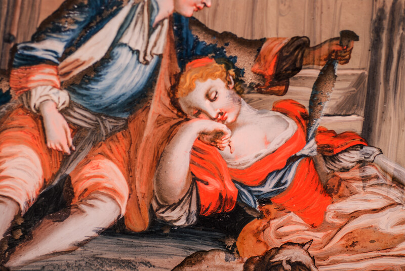 An eighteenth century reverse painting on glass. In a black frame.