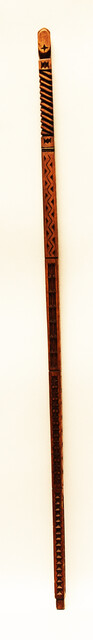 An extensively carved Dutch wooden ellrule with a brass stop.