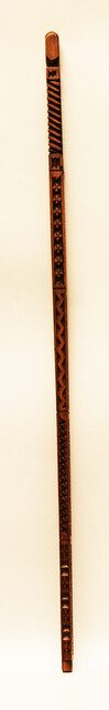 An extensively carved Dutch wooden ellrule with a brass stop.