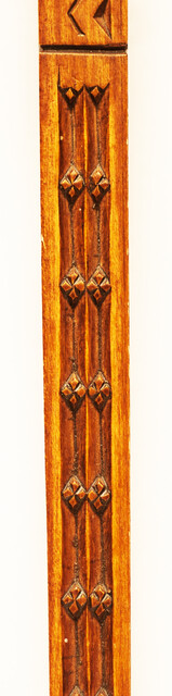 An extensively carved Dutch wooden ellrule with a brass stop.