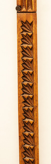An extensively carved Dutch wooden ellrule with a brass stop.