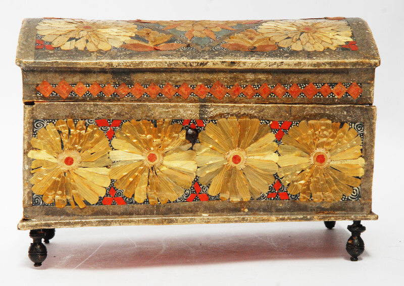 An Seventeenth Century small box decorated with flower leaves and a stylized butterfly.