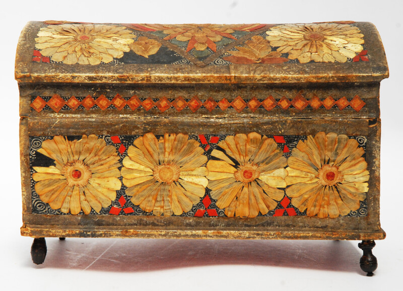 An Seventeenth Century small box decorated with flower leaves and a stylized butterfly.