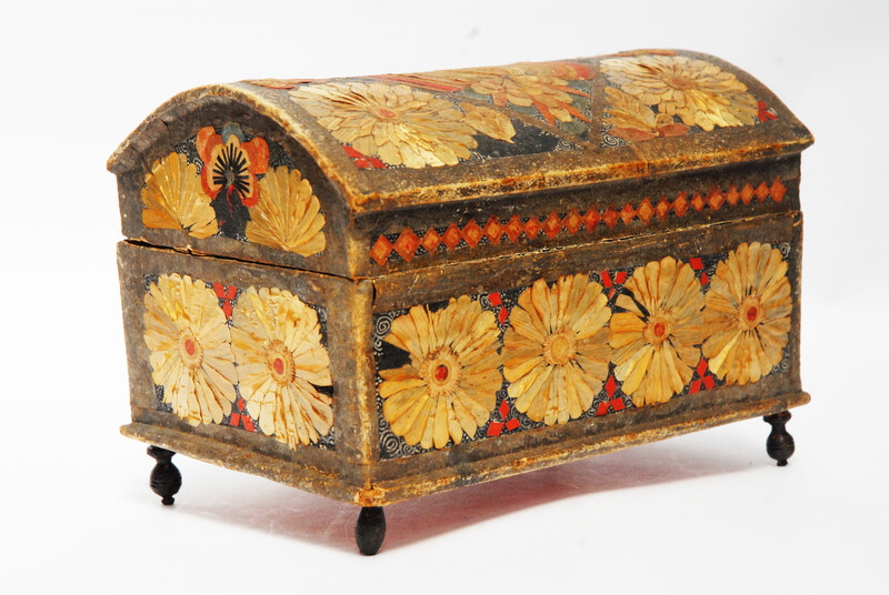 An Seventeenth Century small box decorated with flower leaves and a stylized butterfly.