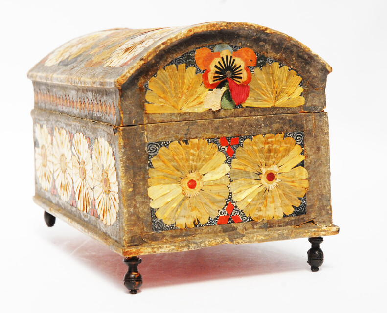 An Seventeenth Century small box decorated with flower leaves and a stylized butterfly.
