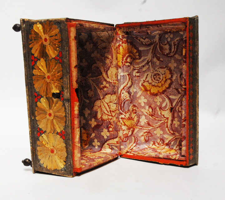 An Seventeenth Century small box decorated with flower leaves and a stylized butterfly.