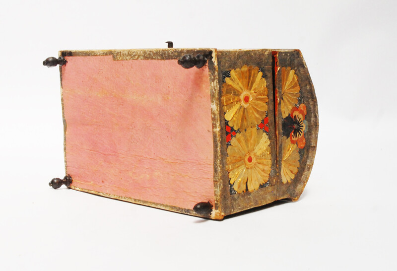 An Seventeenth Century small box decorated with flower leaves and a stylized butterfly.