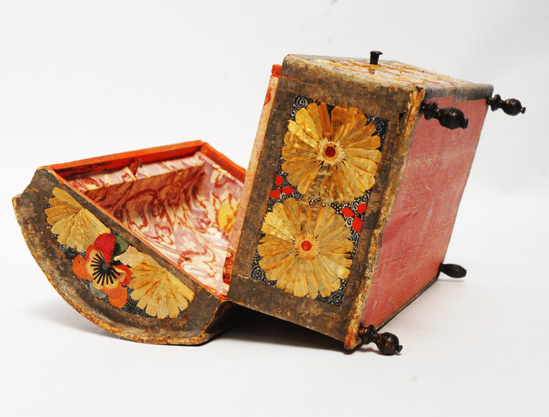 An Seventeenth Century small box decorated with flower leaves and a stylized butterfly.