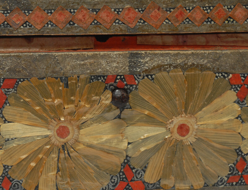 An Seventeenth Century small box decorated with flower leaves and a stylized butterfly.