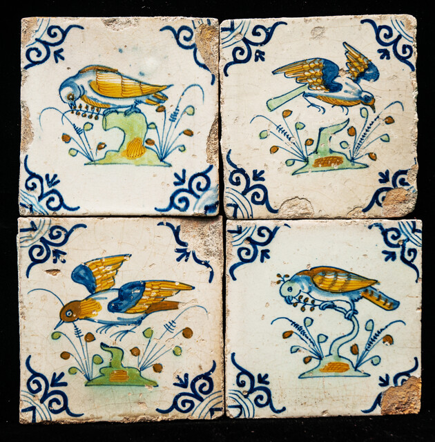Four extremely rare early 17th C. multicoloured Gouda tiles with birds.