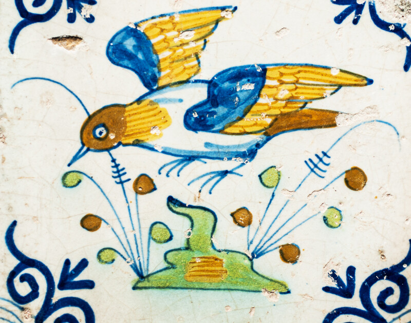 Four extremely rare early 17th C. multicoloured Gouda tiles with birds.