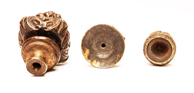 Three bronze flame shaped top ornaments.