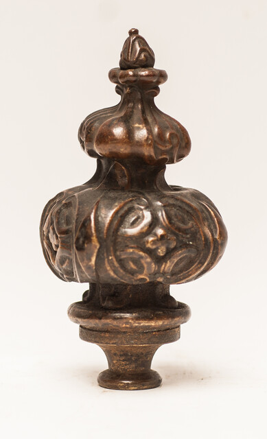 Three bronze flame shaped top ornaments.