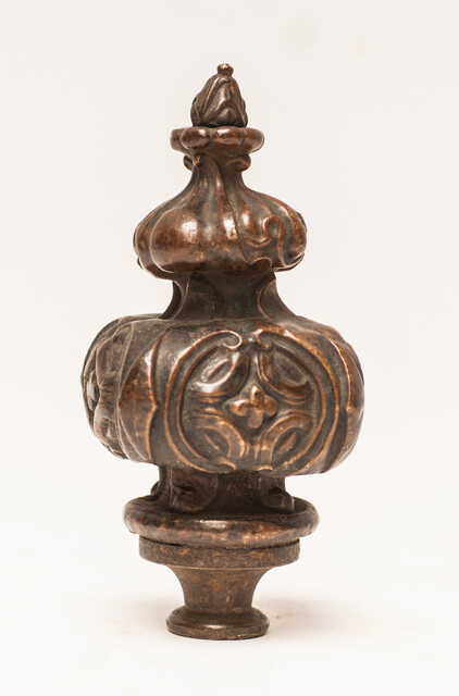 Three bronze flame shaped top ornaments.