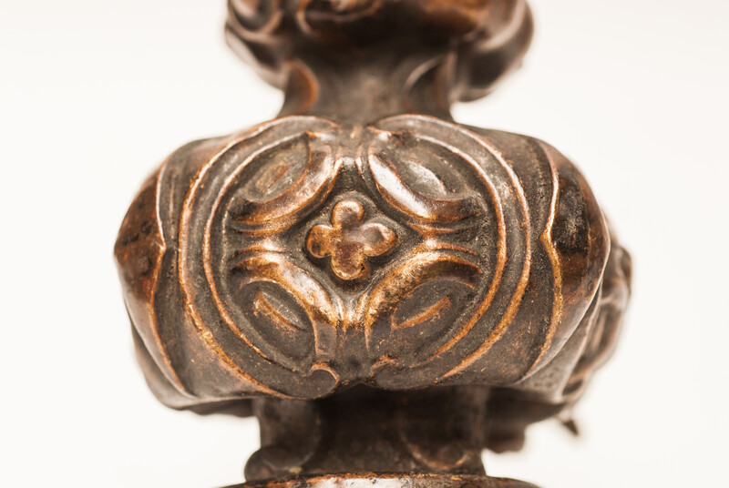 Three bronze flame shaped top ornaments.