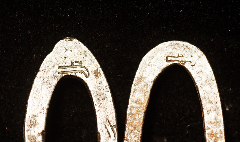 Two flint irons with a blacksmiths touch mark of a pistol.