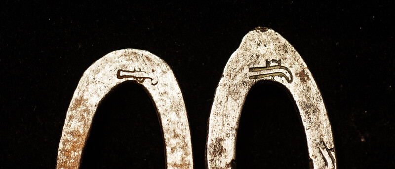 Two flint irons with a blacksmiths touch mark of a pistol.