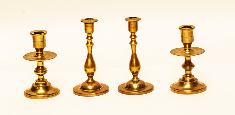 Two pair of brass nineteenth century travelling candle sticks.