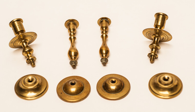 Two pair of brass nineteenth century travelling candle sticks.